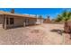 Private backyard features desert landscaping, mature trees, and covered patio at 5237 W Mountain View Rd, Glendale, AZ 85302