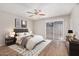 Comfortable bedroom featuring warm decor, wood floors, and sliding door at 5237 W Mountain View Rd, Glendale, AZ 85302