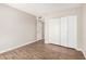 This bedroom offers wood-look flooring, closet, and neutral paint at 5237 W Mountain View Rd, Glendale, AZ 85302