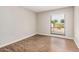 Bright bedroom with wood-look flooring and a window overlooking the front yard at 5237 W Mountain View Rd, Glendale, AZ 85302