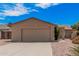 Single-story home featuring a neutral color scheme, two-car garage, and rock landscaping at 5237 W Mountain View Rd, Glendale, AZ 85302