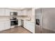 Modern kitchen with stainless steel appliances, white cabinets, and updated countertops at 5237 W Mountain View Rd, Glendale, AZ 85302