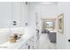 Contemporary kitchen with white cabinetry, subway tile backsplash, and open view to the rest of the home at 5919 E Corrine Dr, Scottsdale, AZ 85254