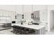 Modern kitchen with stainless steel appliances, white cabinets, an island, and stylish pendant lighting at 5919 E Corrine Dr, Scottsdale, AZ 85254