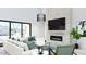 Bright living room featuring a modern fireplace, comfortable seating, and large windows with desert views at 5919 E Corrine Dr, Scottsdale, AZ 85254