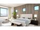 Serene main bedroom with accent wall, bench seat, and large window, creating a relaxing retreat at 5919 E Corrine Dr, Scottsdale, AZ 85254