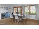 Dining room with a large wooden table, six chairs, blue cabinets and views of the yard through two windows at 6648 E Horseshoe Rd, Paradise Valley, AZ 85253