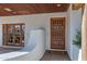 Close-up of the front door showcasing a custom design, sidelights, and a welcoming mat at 6648 E Horseshoe Rd, Paradise Valley, AZ 85253