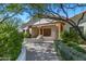 Charming front entrance featuring stone accents, a covered porch, and mature landscaping at 6648 E Horseshoe Rd, Paradise Valley, AZ 85253
