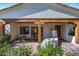 Inviting front porch with decorative wooden beams, comfortable seating, and a stone accent wall at 6648 E Horseshoe Rd, Paradise Valley, AZ 85253