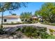 Well-manicured front yard with mature trees and landscaping, showcasing the home's entrance at 6648 E Horseshoe Rd, Paradise Valley, AZ 85253