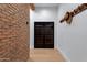 Hallway with a wine refrigerator, brick wall and light wood floors at 6648 E Horseshoe Rd, Paradise Valley, AZ 85253
