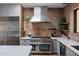 Modern kitchen with stainless steel appliances, quartz countertops, and stylish brick backsplash at 6648 E Horseshoe Rd, Paradise Valley, AZ 85253