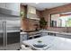 Modern kitchen with stainless steel appliances, a large island, and stylish brick accents at 6648 E Horseshoe Rd, Paradise Valley, AZ 85253