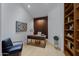 Stylish home office features a wood paneled wall and custom shelving at 6648 E Horseshoe Rd, Paradise Valley, AZ 85253