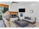 Inviting outdoor living space with comfortable seating, fireplace, ceiling fan and serene backyard views at 6648 E Horseshoe Rd, Paradise Valley, AZ 85253