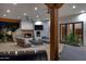 Inviting outdoor living space with comfortable seating, fireplace, ceiling fan and serene backyard views at 6648 E Horseshoe Rd, Paradise Valley, AZ 85253