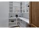Well-organized walk-in pantry with white shelves and quartz countertops that add a touch of elegance at 6648 E Horseshoe Rd, Paradise Valley, AZ 85253