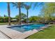 Inviting pool area with lounge chairs, umbrellas, lush landscaping, and tall palm trees at 6648 E Horseshoe Rd, Paradise Valley, AZ 85253