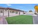 Spacious backyard featuring a covered patio, green turf and pool area at 753 W Pampa Ave, Mesa, AZ 85210