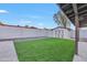 Backyard featuring green turf, shed, and secure perimeter fence at 753 W Pampa Ave, Mesa, AZ 85210