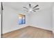 This bright bedroom features a ceiling fan and a large window at 753 W Pampa Ave, Mesa, AZ 85210