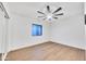 This bright bedroom features a ceiling fan and a large window at 753 W Pampa Ave, Mesa, AZ 85210