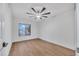 Bright bedroom with modern ceiling fan, wood floors and large window at 753 W Pampa Ave, Mesa, AZ 85210