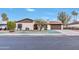 Charming home featuring a front lawn with a tree, driveway, and a two-car garage at 753 W Pampa Ave, Mesa, AZ 85210