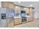 This home has a kitchen with light wood cabinets, stainless steel appliances, and stone countertops at 753 W Pampa Ave, Mesa, AZ 85210
