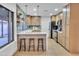 Well-lit kitchen with a breakfast bar, modern appliances, and ample cabinet space at 753 W Pampa Ave, Mesa, AZ 85210