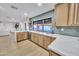 This home has a bright kitchen with light wood cabinets, stone countertops, and stainless steel appliances at 753 W Pampa Ave, Mesa, AZ 85210