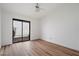 Open bedroom featuring wood floors and a sliding glass door leading to the backyard patio at 7565 N Vía De La Siesta --, Scottsdale, AZ 85258