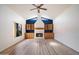 Bright living room showcases a cozy fireplace and custom wood built-ins, complemented by modern flooring at 7565 N Vía De La Siesta --, Scottsdale, AZ 85258