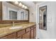 Bathroom vanity with granite counters, decorative mirror and updated fixtures at 7835 E Glenrosa Ave # 13, Scottsdale, AZ 85251