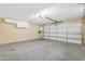 Garage features white cabinets, large door, and ample space at 7835 E Glenrosa Ave # 13, Scottsdale, AZ 85251