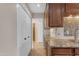Kitchen with granite counters, tile backsplash, wood cabinets and a view through a doorway at 7835 E Glenrosa Ave # 13, Scottsdale, AZ 85251