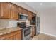Kitchen featuring granite countertops, stainless steel appliances, tile backsplash, and wood cabinets at 7835 E Glenrosa Ave # 13, Scottsdale, AZ 85251