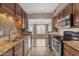 Kitchen with granite countertops, stainless steel appliances, tile backsplash, and view into the dining area at 7835 E Glenrosa Ave # 13, Scottsdale, AZ 85251