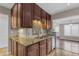 Kitchen with granite countertops, mosaic backsplash, stainless steel appliances, and wood cabinets at 7835 E Glenrosa Ave # 13, Scottsdale, AZ 85251
