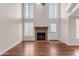 Living room with fireplace, hardwood floors, tall ceilings and bright, natural light with a door to the outside at 7835 E Glenrosa Ave # 13, Scottsdale, AZ 85251