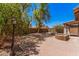Spacious backyard with mature landscaping, a brick patio, and a serene water fountain feature at 8037 W Mohave St, Phoenix, AZ 85043
