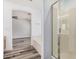 Bright bathroom featuring soaking tub, glass-enclosed shower, and access to main bedroom at 8037 W Mohave St, Phoenix, AZ 85043