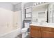 Bathroom featuring a shower-tub combo, white toilet, wood-look floors, and a single sink vanity at 8037 W Mohave St, Phoenix, AZ 85043