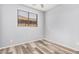 Well-lit bedroom with wood-look floors and natural light from the window at 8037 W Mohave St, Phoenix, AZ 85043