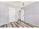 A bright bedroom with a ceiling fan, modern gray walls, and wood-look flooring at 8037 W Mohave St, Phoenix, AZ 85043