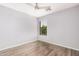 A bright bedroom with light walls, a ceiling fan, and modern wood-look flooring at 8037 W Mohave St, Phoenix, AZ 85043