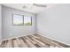 Bedroom featuring wood-look floors, white ceiling fan and natural light from the window at 8037 W Mohave St, Phoenix, AZ 85043