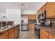 Kitchen with stainless steel appliances, wood cabinets, and marble counter tops at 8037 W Mohave St, Phoenix, AZ 85043
