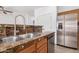 Kitchen featuring stainless steel appliances, wood cabinets, granite counter tops and a double sink at 8037 W Mohave St, Phoenix, AZ 85043